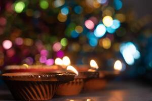 Glowing clay lanterns during Indian festival Diwali celebrations with bokeh effect background with copy space. photo