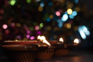 Glowing clay lanterns during Indian festival Diwali celebrations with bokeh effect background with copy space. photo