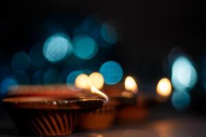 Glowing clay lanterns during Indian festival Diwali celebrations with bokeh effect background with copy space. photo