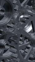A close-up perspective showcases a series of rotating interlocking metal gears, highlighting the precise engineering and the complexity of mechanical design in machinery. vertical footage video