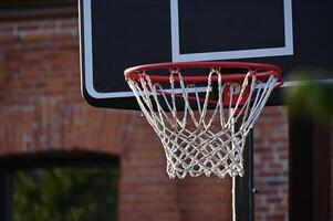 a basketball hoop is shown in front of a brick building photo