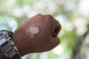 Man which is covered with a plaster or adhesive bandage after blood test. photo