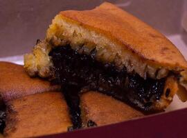 terang bulan with chocolate flavor. sweet martabak with chocolate flavor. snacks that are often sold on Indonesian roadsides. photo