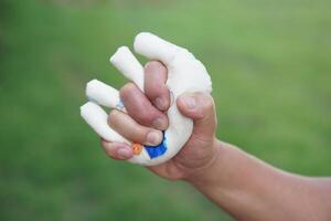 Hand muscle exercises for paralyzed patient by squeezing soft objects stuffed with sponges that fit with fingers locking. Concept, Healthcare for physical therapy to strengthen or recovery weak muscle photo