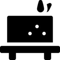 A black and white icon of a cake on a table vector