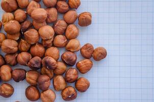 hazelnuts without shell on a light background in a check photo