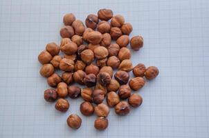 hazelnuts without shell on a light background in a check photo