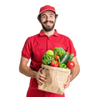 Smiling delivery man with red uniform holding a shopping bag full of vegetable front view isolate on transparency background png