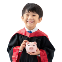 Smiling little boy wearing graduation gown uniform standing with hand holding piggy bank side view isolate on transparency background png