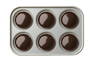 Chocolate treats in a baking tray ready for indulging after cooling on a countertop png