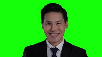 Smiling Businessman in Formal Suit on Green Screen Background. Professional Male Executive Ready Presentation, Webinar, Digital Content with Customizable Backdrop for Business Communication video