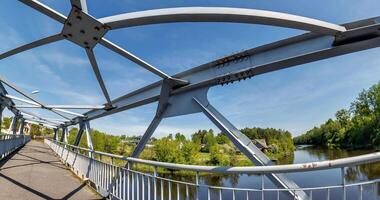 loop rotation on iron steel frame construction of bridge on blue sky background. bridge metal structures, frames, bolts and nuts video