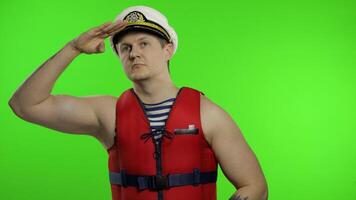 Young muscular sailor man works as lifeguard at beach observe the territory video