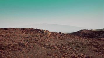 Expansive view of rolling hills and distant mountains under a clear sky video