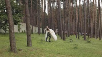 Lovely newlyweds caucasian bride groom dancing in park, making kiss, wedding couple family video