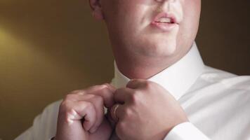 Stylish man in jacket fastens buttons, buttoning white shirt preparing to go out near window video