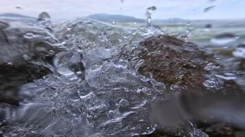 Splash of the waves between the rocks in slow motion video