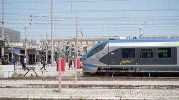 High-speed train waits for passengers on platform at station video