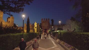 Tourists walk on road leading to ancient Lazise Castle video