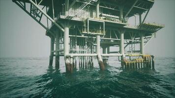Old oil platform standing in open waters under a clear sky video