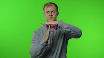 Man showing time out sign. This is limit, enough gesture. Portrait of guy on chroma key background video