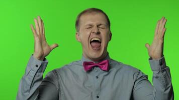Happy man raising fist in victorious gesture, dancing, celebrating great success, enjoying lucky day video