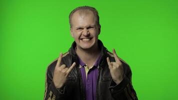 Rocker man showing rock and roll sign, devil horns gesture, looking with crazy expression video
