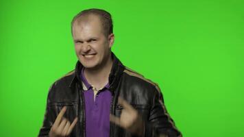 Rocker man showing rock and roll sign, devil horns gesture, looking with crazy expression video