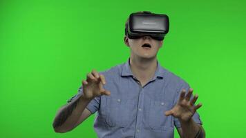 Man using VR headset helmet to play game. Watching virtual reality 3d 360 . Chroma key video
