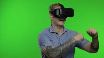 Man using VR headset helmet to play game. Watching virtual reality 3d 360 . Chroma key video