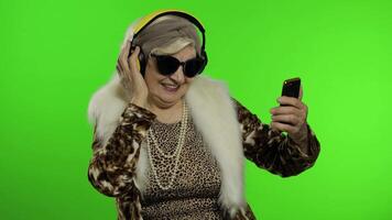 Elderly caucasian grandmother woman. Dance, celebrate, listen music. Chroma key video