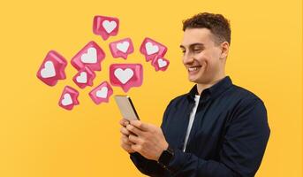 Positive cool european guy using smartphone isolated on yellow studio background, texting girlfriend, using newest dating mobile app photo