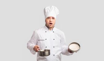 Oops. Puzzled Cook Man Opening Saucepan Looking At Camera Standing On White Studio Background. Panorama photo