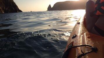 Kayaking Ocean Sunset California - A close-up view of a woman kayaking in the ocean with the sunset in the background. The photo was likely taken in California. video