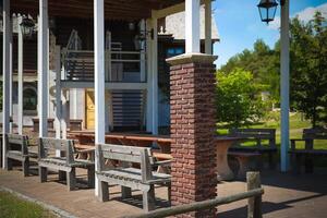 A small establishment with benches outside on the veranda photo