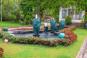 Fountain in the prka with green grass photo