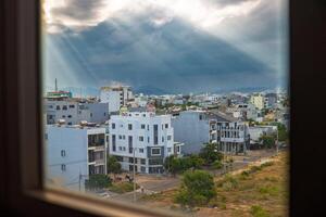 View from the window of the beautiful rays of the sun directed at the city photo