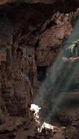 A cave with sunlight coming through the rocks video