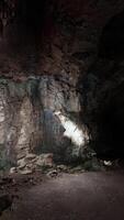 A cave with a light at the end of it video