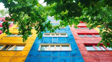 A multi-colored building with many windows and trees in front of it video