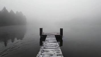 A wooden dock in the middle of a foggy lake video