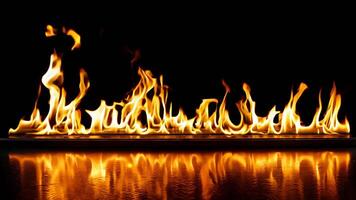 A fire is burning in the dark with a reflection in the water video