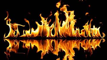 A fire is reflected in the water on a black background video