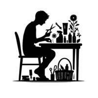 A silhouette of a man sitting at a table with scissors and other tools vector