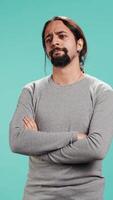 Vertical Man shakes head, showing negative emotion, showing lack of satisfaction, isolated over studio background. Irked person disagreeing with friend during conversation, studio backdrop, camera B video
