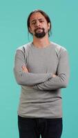 Vertical Man shakes head, showing negative emotion, showing lack of satisfaction, isolated over studio background. Irked person disagreeing with friend during conversation, studio backdrop, camera A video