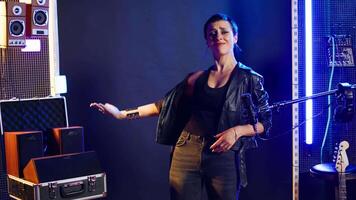 Musical talent vocalist showing the mute symbol to be silent, emphasizing empowerment and no hate. Rock star woman doing a hush sign for a cultural statement, rebellious attitude. Camera A. video