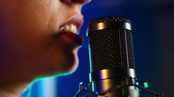 Punk rock artist singing a heavy metal alternative song on microphone, creating an iconic fierce wild performance at nightclub. Superstar performer with a cool style. Close up. Camera A. video