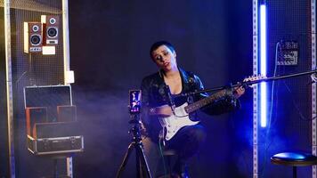 Punk rock musician hosting a live event concert on online streaming session, singing heavy metal alternative music in the studio. Artist doing a digital performance on social media. Camera B. video