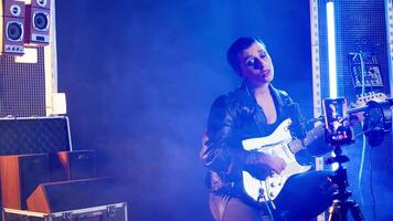 Punk rock musician hosting a live event concert on online streaming session, singing heavy metal alternative music in the studio. Artist doing a digital performance on social media. Camera A. video